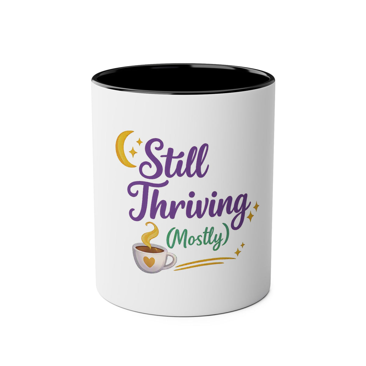 A white ceramic mug with a black interior, featuring a graphic design on the front that reads 'Still Thriving (Mostly)' in purple and green lettering, accompanied by a yellow crescent moon, stars, and a small coffee cup illustration.