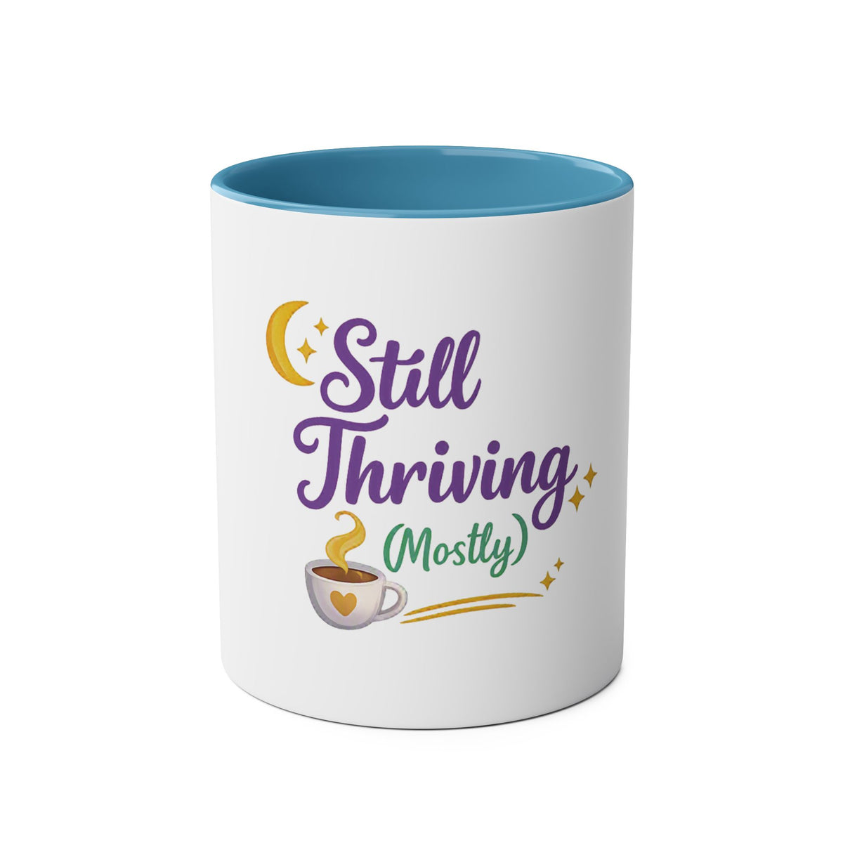 A white ceramic mug with a contrasting blue interior, featuring a graphic design on the front that reads 'Still Thriving (Mostly)' in purple and green lettering, accompanied by a yellow crescent moon, stars, and a small coffee cup illustration.